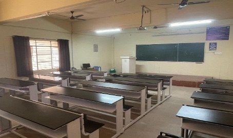 Classroom B116A with benches and green board