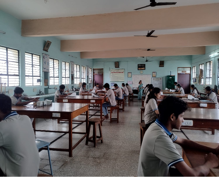 Physics Lab-I T-206, students at benches during a practical session